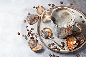 Mushroom coffee, a ceramic cup, mushrooms and coffee beans on stone concrete background. New Superfood Trend