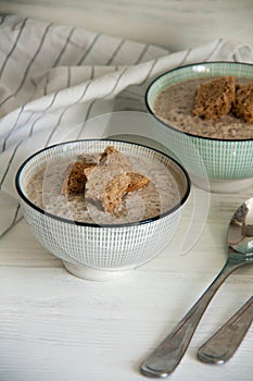 Mushroom cream soup with bread crumbs in two deep bowls