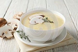 Mushroom cream soup on wooden background