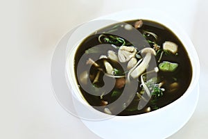 Mushroom curry with herb juice in white bowl, Thai food.