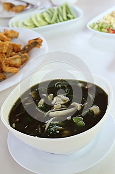 Mushroom curry with herb juice in white bowl, Thai food.