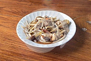 Mushroom fried in white plate on wood table