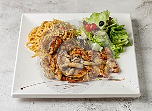 mushroom grill chicken with aglio pasta and salad served in dish isolated grey background top view singapore fast food