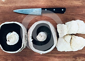 Mushroom and knife on chopping block