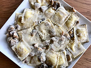 Mushroom Ravioli Pasta with Cream Sauce in Rectangular Plate photo