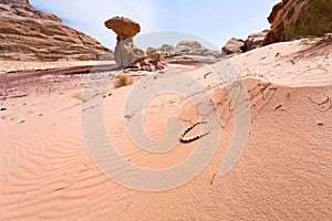Mushroom rock and arabic bead in desert