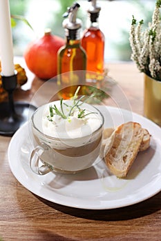 Mushroom soup. Bolete mushrooms cream with rosemary and garlic foam, served with toast with olive oil.