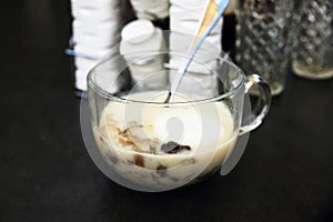 Mushroom soup, container, custers and glasses on black. photo