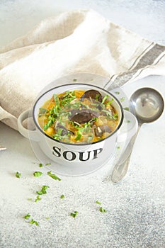 Mushroom soup with greens and processed cheese