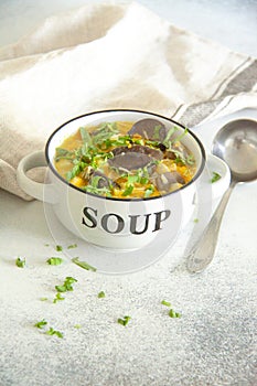 Mushroom soup with greens and processed cheese