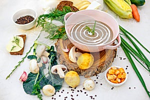 Mushroom soup with vegetables and herbs on the table