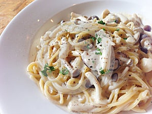 Mushroom spaghetti on wooden table - top view