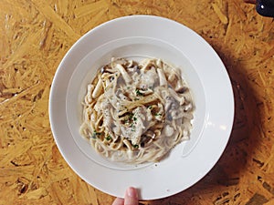 Mushroom spaghetti on wooden table - top view