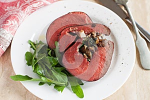 Mushroom and spinach stuffed beef heart with arugula