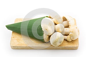 Mushroom wrap with banana leaves on cutting board