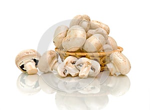 Mushrooms (Agaricus) in basket on white background