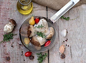 Mushrooms ceps with herbs in a skillet photo