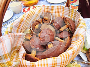 Mushrooms chocolate candy holiday snacks cookies festive food in basket on table picnic feast outdoors