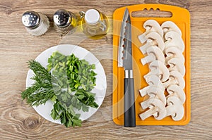 Mushrooms on cutting board, spices, bottle of vegetable oil, gre