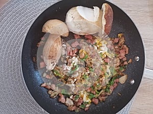 Mushrooms with ham and eggs in a pan from above