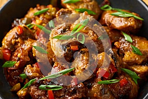 Mushrooms Manchurian dry in black bowl at dark slate background