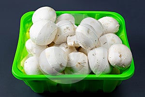 Mushrooms in packing on a dark background