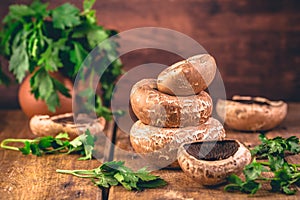 Mushrooms Porto Bello on kitchen table with fresh herbs
