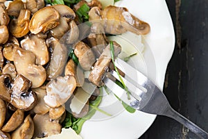 Mushrooms with vegetables on a white plate