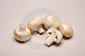 Whole and sliced button mushrooms on a seamless background