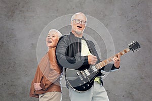 Happy senior couple with electric guitar singing