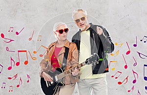 Senior couple in sunglasses with electric guitar