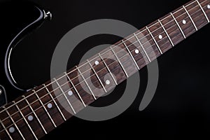 Music and art. Electric guitar on a black isolated background. Horizontal frame