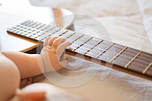 Baby arm on guitar photo
