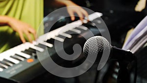 Music band concept background.Selective focus microphone and blurred man playing