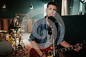 Music band having rehearsal in a studio photo