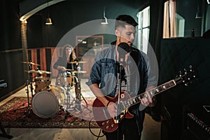 Music band having rehearsal in a studio