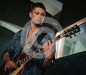 Music band having rehearsal in a studio