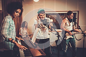 Music band performing in a studio