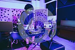 Music band streaming live performance online in boutique recording studio - Soft focus on influencer led with mobile phone