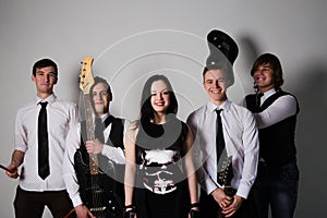 music band in studio.Musicians and woman soloist posing over white background