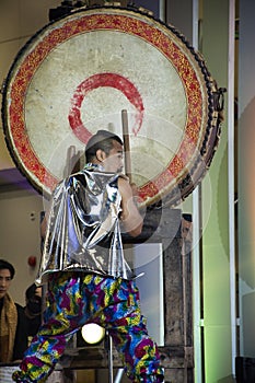 Music band and thai men actress or musician playing hit classic instrument big gong drum and dancing to the beat for show visitor