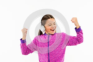 Music is the best motivation. Active child enjoy music playing in earphones isolated on white. Energetic little kid