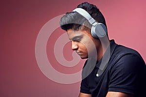 Music is capable of making us feel emotions. Studio shot of a handsome young man wearing headphones.