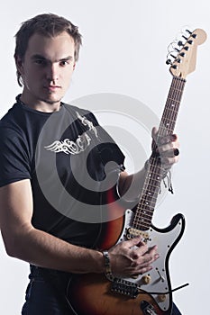 Music Concepts and Ideas. Portrait of caucasian Male Guitar Player Posing With Instrument Against White