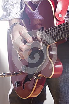 Music Concepts. Male Guitar Player Performing with Electric Guit