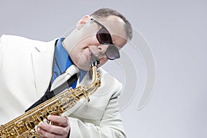 Music Concepts. Mature Musician Playing Alto Saxophone and Wear