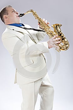 Music Concepts. Natural Portrait of Expressive Male Saxophone Mu