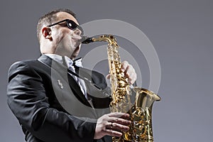 Music Concepts. Portrait of Mature Expressive Caucasian Saxophone Musician