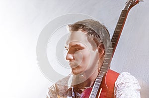 Music Concepts. Portrait of Young Male Guitar Player Against Gra