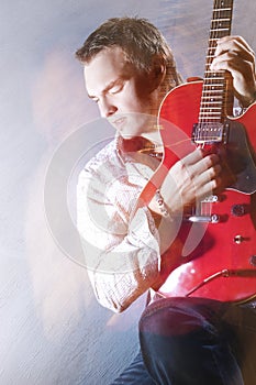 Music Concepts. Portrait of Young Male Guitar Player Performing